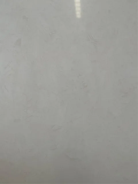 gray engineered stone slab, with a single full slab and cloudy mottling, in a close surface view