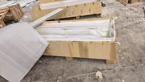 white stone fireplace surround, with visible white stone variation, in protective packing