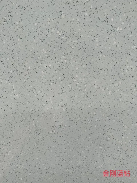 gray engineered stone slab, with a single full slab and a speckled texture, in a close surface view