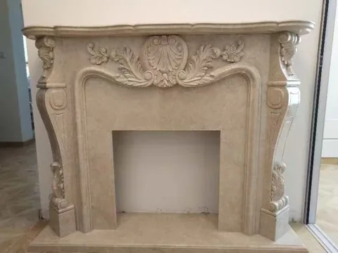 White Volakas marble fireplace surround, with cloudy mottling, in a showroom