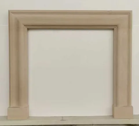 White Volakas marble fireplace surround, with a plain surface and a matte finish, on a plain backdrop