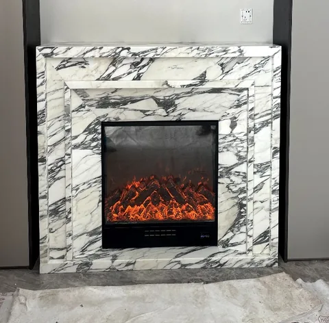 Arabescato Corchia marble fireplace surround, with stepped tiers and bold veining, against a pale background