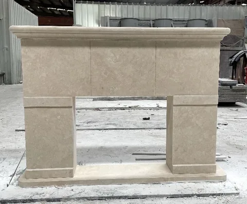 White Volakas marble fireplace surround, with cloudy mottling, in a workshop