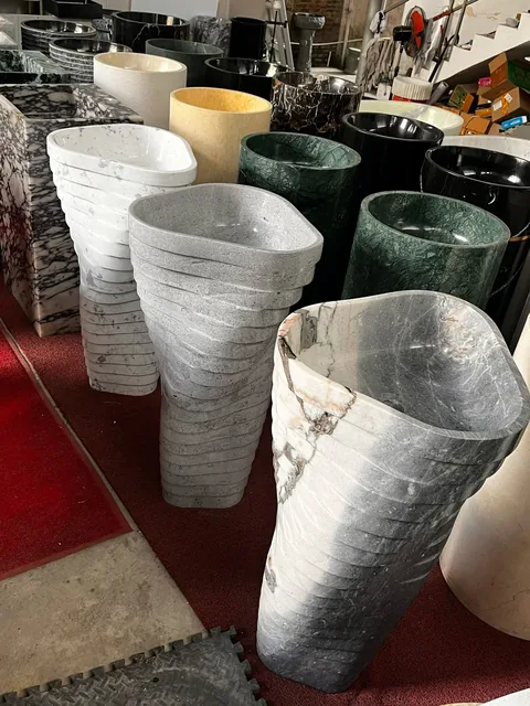 gray stone sink, with bold veining, in a workshop