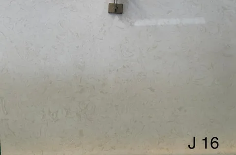 cream-beige engineered stone slab, with a single full slab and cloudy mottling, in a close surface view