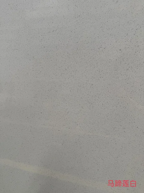 gray engineered stone slab, with a single full slab and a speckled texture, in a close surface view