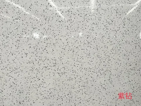 gray engineered stone slab, with a single full slab and a speckled texture, in a close surface view
