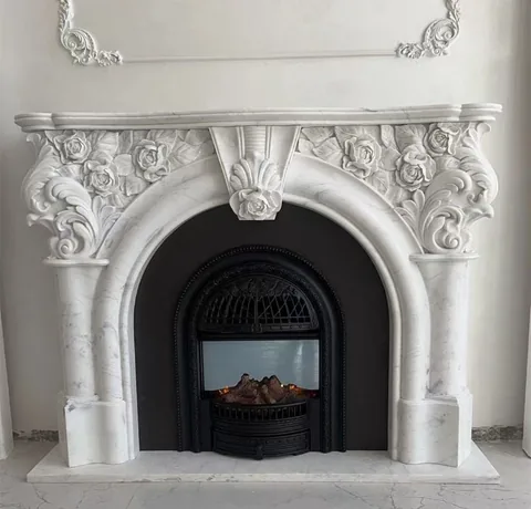 White Volakas marble fireplace surround, with an arched opening and fine veining, against a pale background