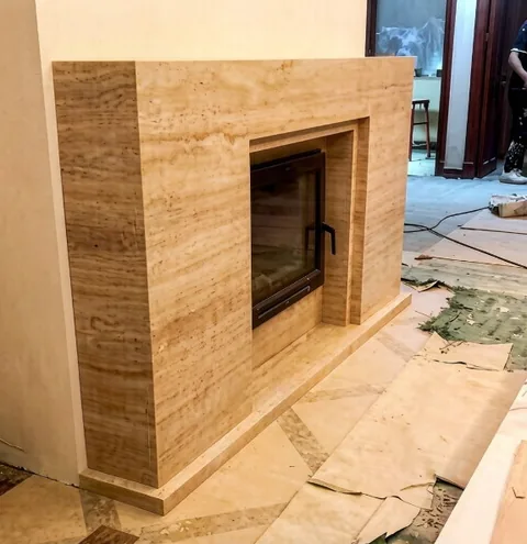 travertine fireplace surround, with linear travertine grain and a soft satin finish, in a workshop