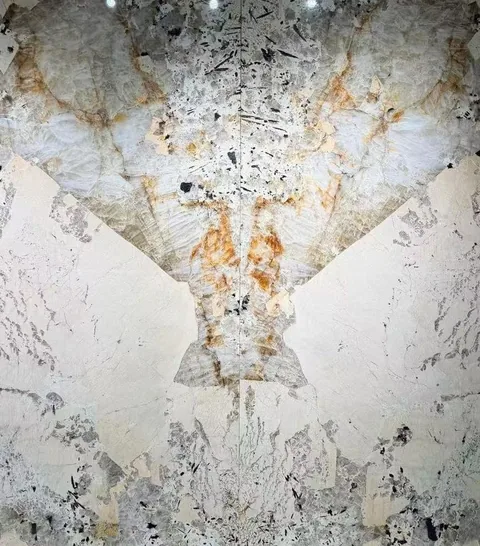 cream-beige stone slab, with a bookmatched slab pair and bold veining, in a close surface view