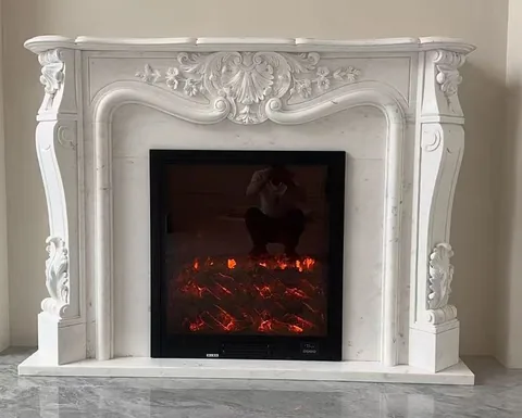 White Volakas marble fireplace surround, shown from a frontal view with subtle pattern contrast