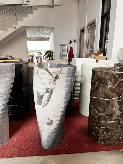 white stone landscape feature, with a stone planter and bold veining, in a showroom