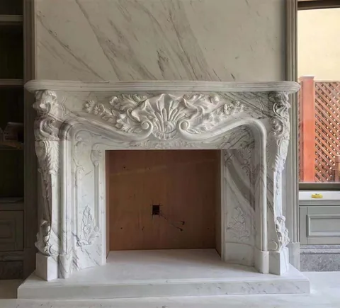 White Volakas marble fireplace surround, with carved scrollwork and fine veining