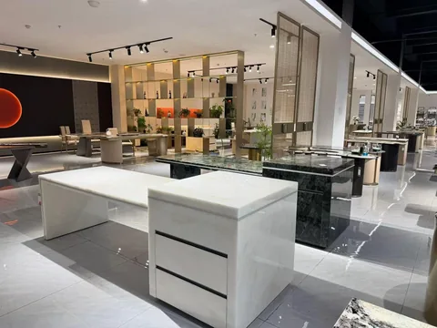 white stone desk, with fine veining and a reflective finish, in a showroom