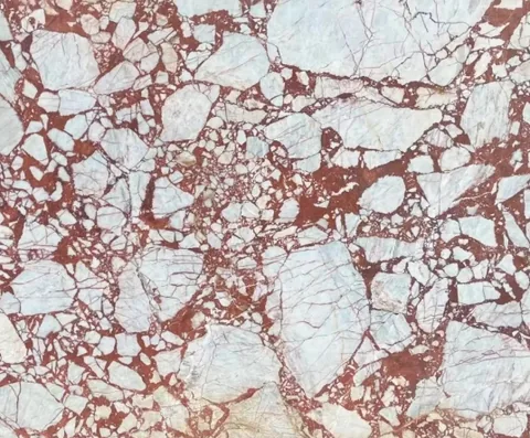 rose-red stone slab, with a single full slab and angular breccia fragments, in a close surface view