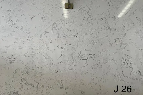white engineered stone slab, with a single full slab and cloudy mottling, in a close surface view