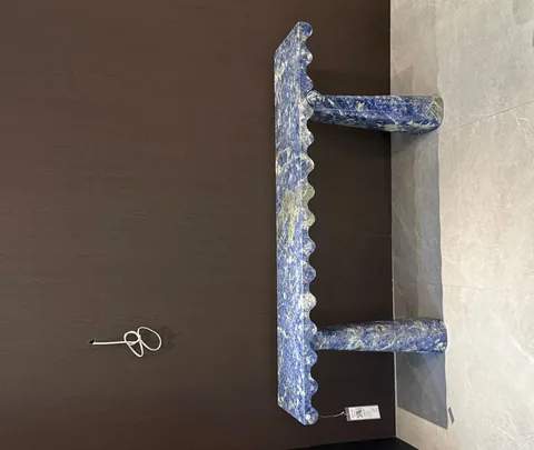 blue stone console table, with twin supporting bases and cloudy mottling, in a showroom