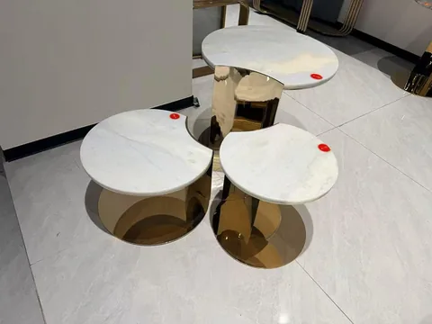 white stone coffee table, with fine veining and a reflective finish, in a showroom