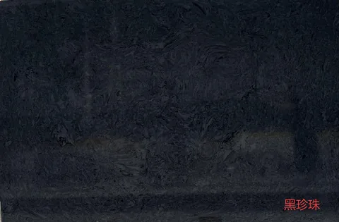 black engineered stone slab, with cloudy mottling, in a close surface view