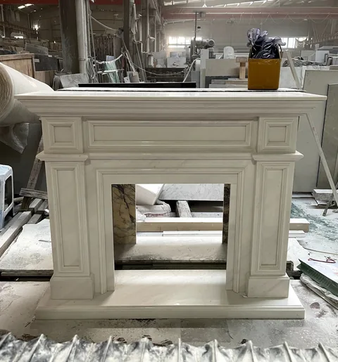 White Volakas marble fireplace surround, with fine veining and a reflective finish, in a workshop