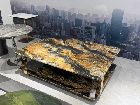 gold stone coffee table, with bold veining and a reflective finish, in a showroom