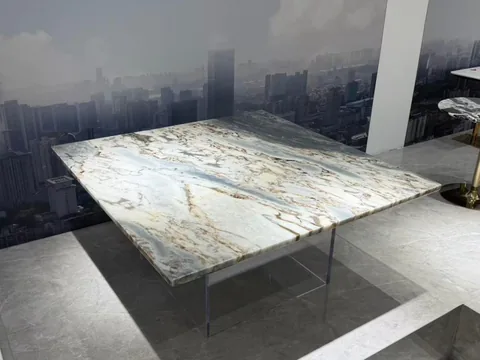 white stone dining table, with a rectangular top and bold veining, in a showroom
