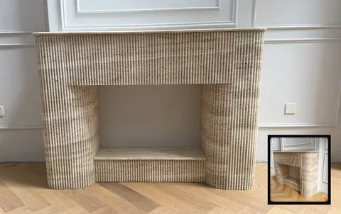 travertine fireplace surround, with a straight recessed opening and linear travertine grain, in a furnished room