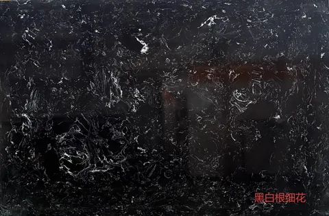 black engineered stone slab, with a single full slab and fine veining, in a close surface view