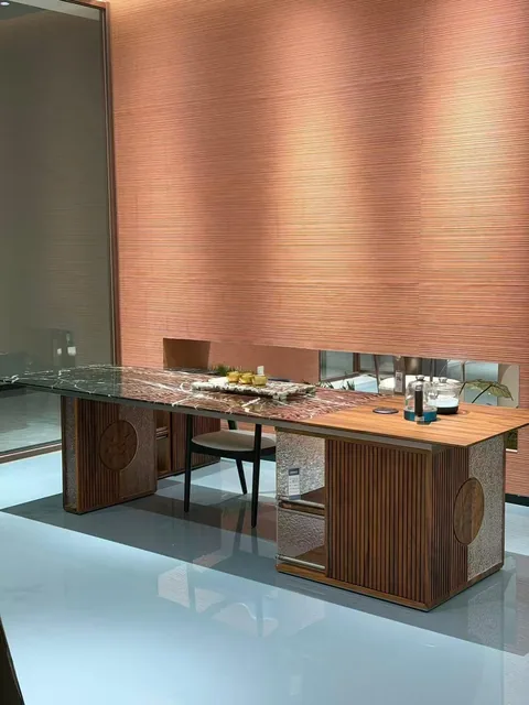 brown stone dining table, with twin supporting bases and bold veining, in a showroom