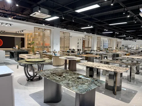 green stone countertop, with a single-level island and bold veining, in a showroom