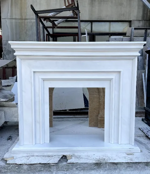 White Volakas marble fireplace surround, with fine veining, showing a single main form with subtle pattern contrast