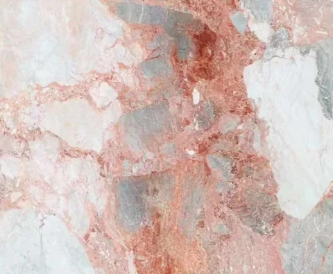 rose-red stone slab, with a single full slab and angular breccia fragments, in a close surface view