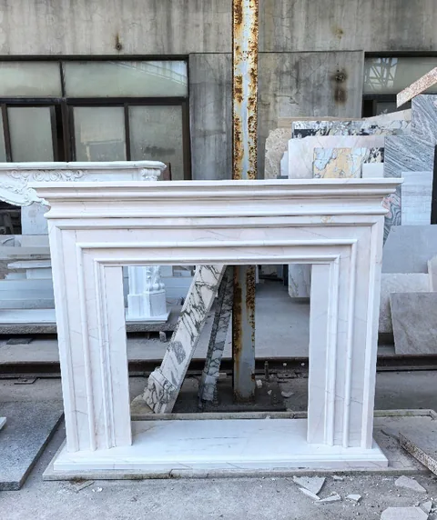 White Volakas marble fireplace surround, with closely spaced markings and subtle pattern contrast
