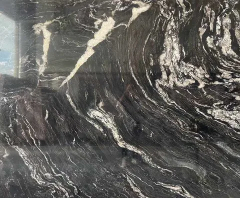 black stone slab, with a single full slab and bold veining, in a close surface view