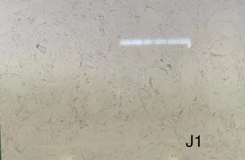 cream-beige engineered stone slab, with cloudy mottling, showing a single main form with an uncluttered setting