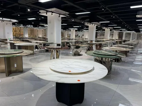 white stone dining table, with fine veining and a reflective finish, in a showroom