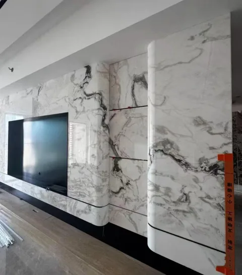 white stone wall feature, with large veined wall panels and bold veining, in a furnished room