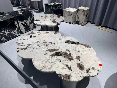 white stone coffee table, with twin supporting bases and cloudy mottling, in a showroom
