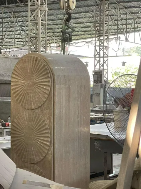 cream-beige stone slab, with a single full slab and a plain surface, in a workshop