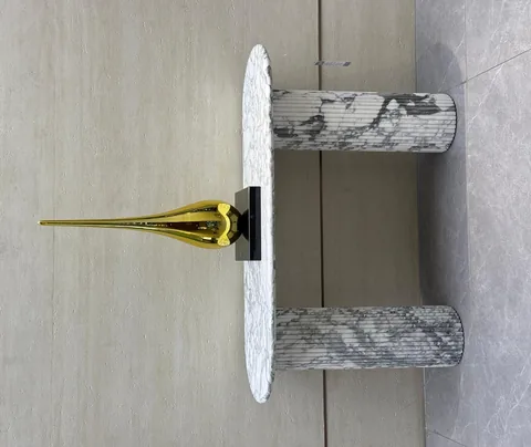 white stone side table, with twin supporting bases and fine veining, in a showroom