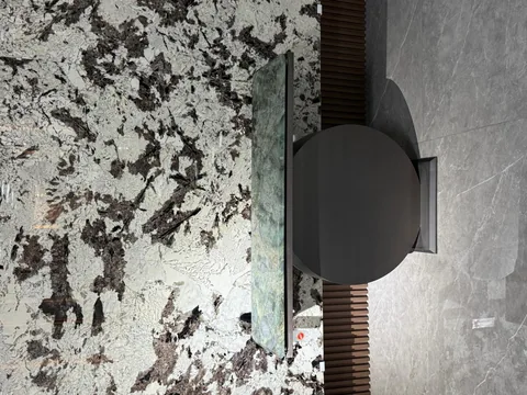 white stone slab, with angular breccia fragments and a reflective finish, in a showroom