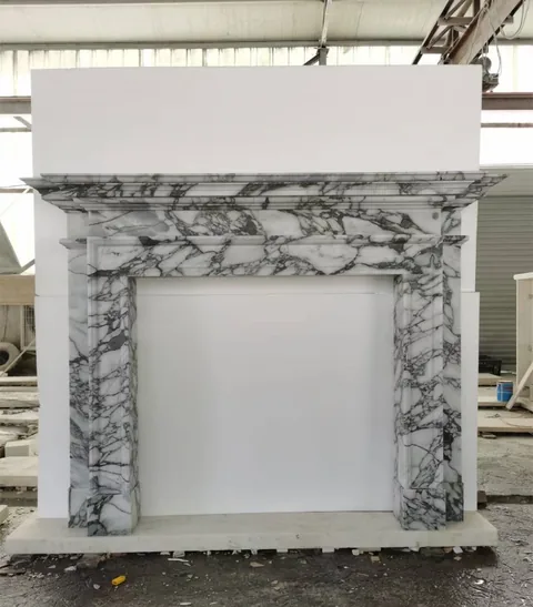 White Volakas marble fireplace surround, with bold veining, in a workshop