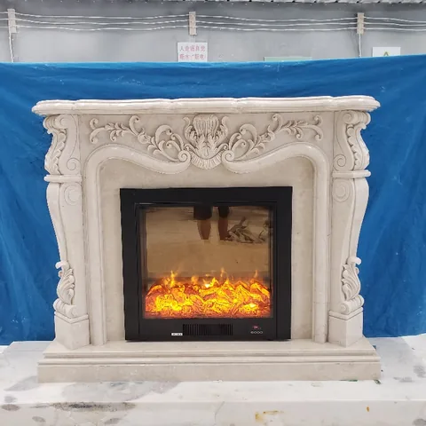 White Volakas marble fireplace surround, with carved scrollwork and fine veining, near workshop equipment