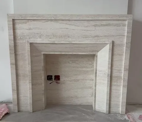 travertine fireplace surround, with stepped tiers and linear travertine grain, in a workshop