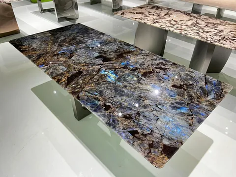 gray stone dining table, with a rectangular top and a crystalline texture, in a showroom