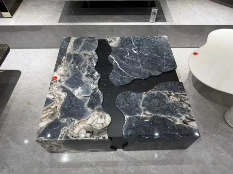gray stone coffee table, with bold veining and a reflective finish, in a showroom