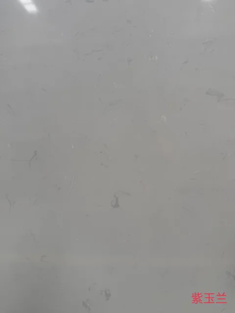 gray engineered stone slab, with a single full slab and fine veining, in a close surface view