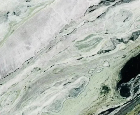 white stone slab, with a single full slab and bold veining, in a close surface view