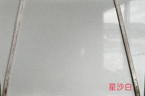 white engineered stone slab, with a single full slab and a speckled texture, in a close surface view