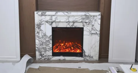 Arabescato Corchia marble fireplace surround, with stepped tiers and bold veining, in a workshop